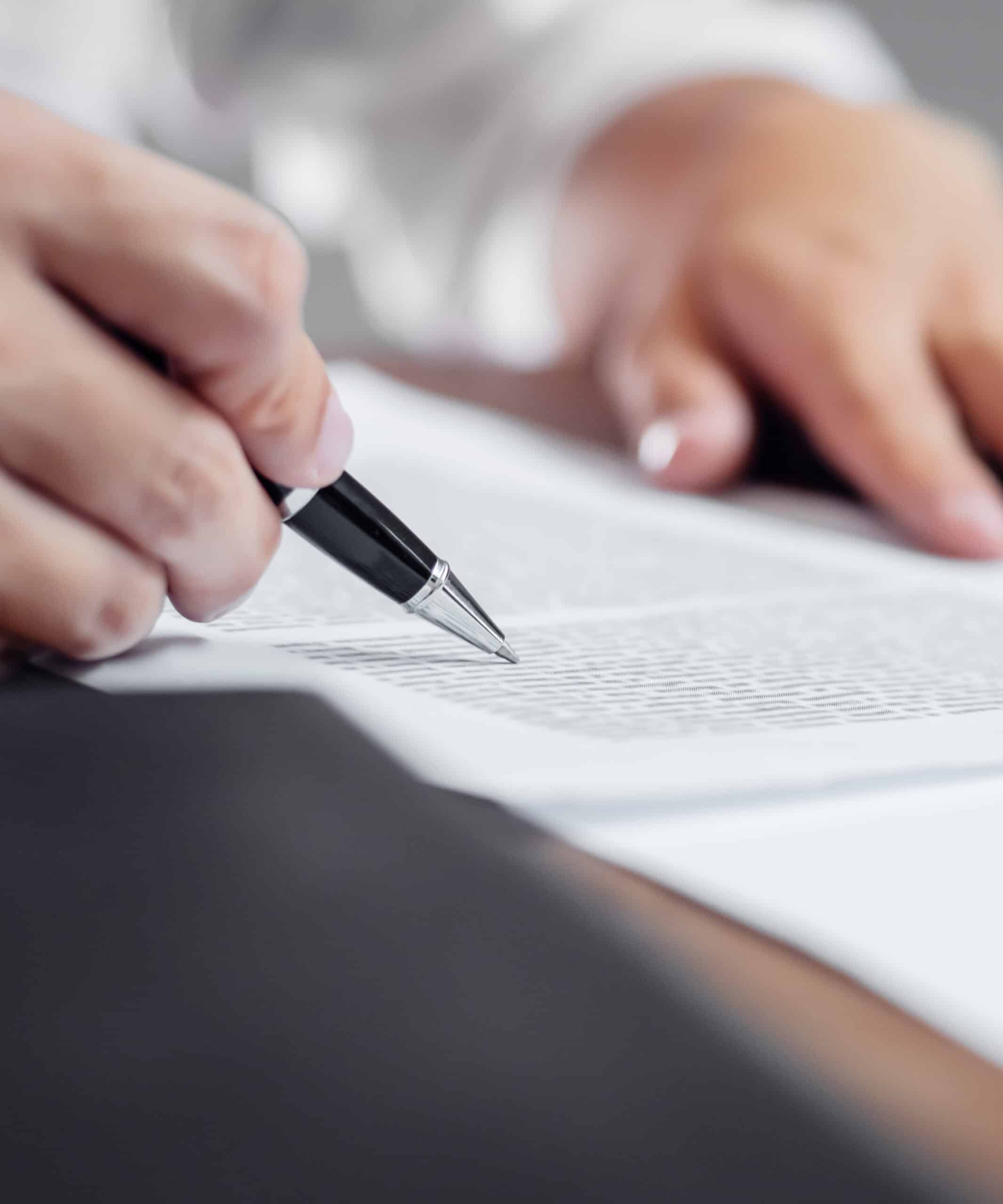 Insurance agent checking policy documents in office.